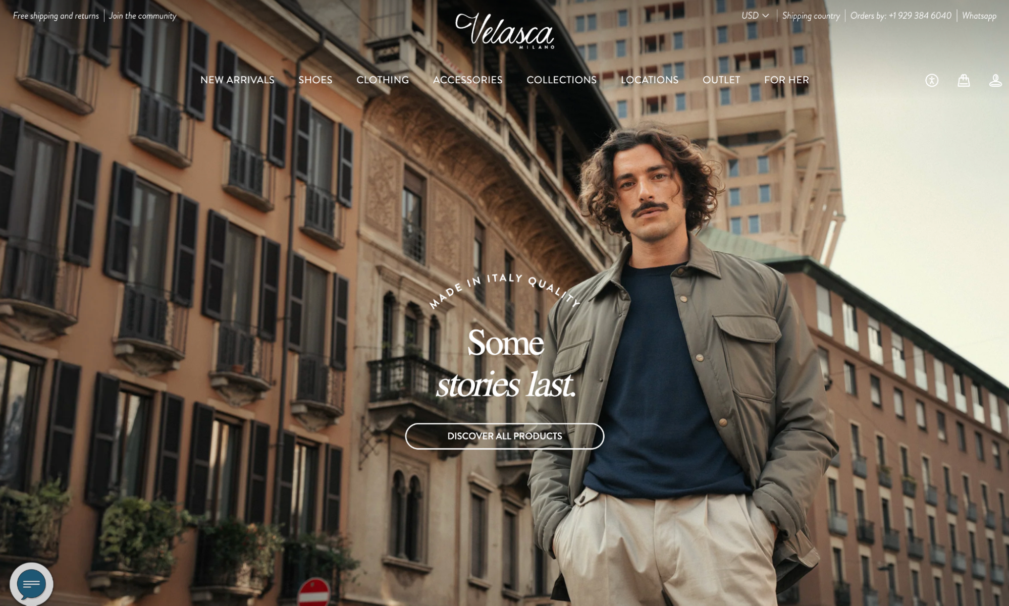 Man in olive jacket and cream pants posing in front of classic European architecture.