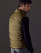 Rear 3/4 body view of man wearing Eco Insulated Vest in Command Green from AETHER Apparel.