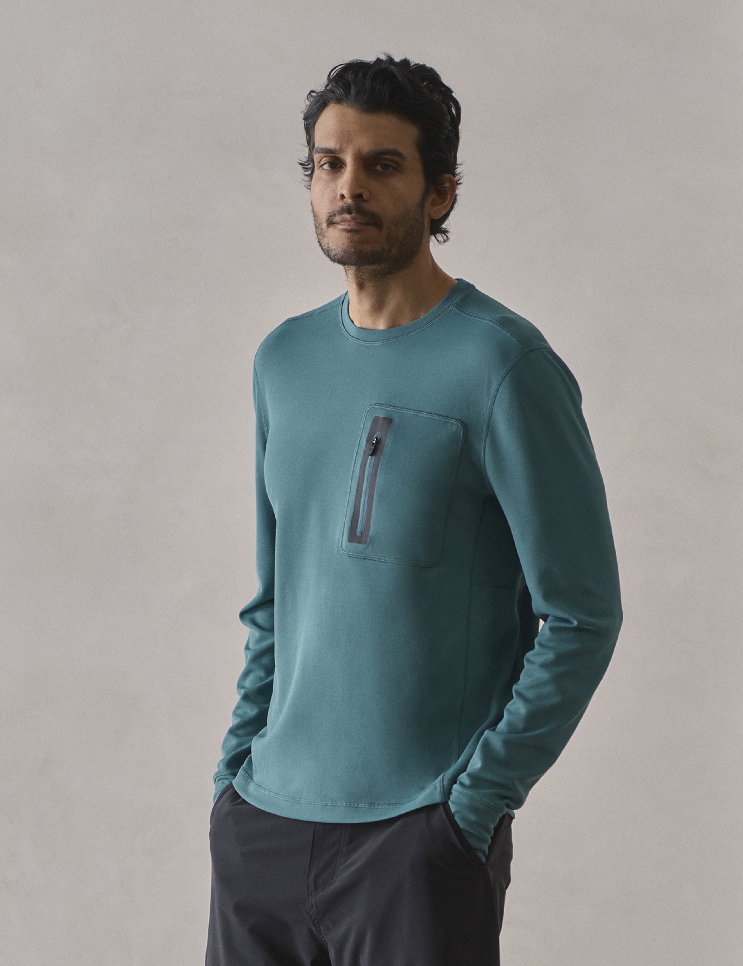 Front 3/4 upper-body view of man wearing Pacific Crewneck Sun Shirt in Aqua Blue from AETHER Apparel.