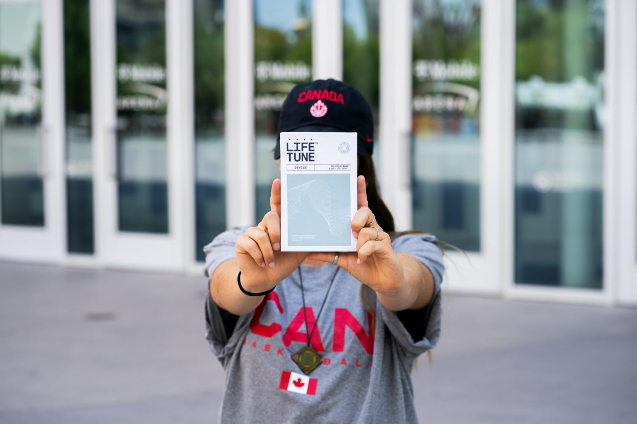 Woman in Canada Basketball gear holding LifeTune box