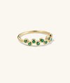 Ziggy Ring featuring bezel-set lab-grown green gemstones in a zig-zag pattern on a gold band, designed for stacking and light-catching sparkle.