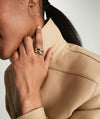 Close-up of a woman's hand wearing the Dôme Figure Ring, showcasing its unique curves and angles, inspired by slow, intentional movement.