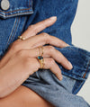 Close-up of a hand wearing the Stacker Ring, showcasing its simple and elegant design as a versatile fashion accessory.