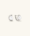 Sloan Pearl Earrings featuring button pearls set in half hoops, combining elegance and modern design for a chic everyday accessory.