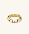 Gold ring with a bead pattern and scalloped edge, named Charlotte Slim Ring, inspired by French dessert.