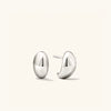 Dôme Huggies: Pair of sculptural silver earrings with a curved, lobe-hugging design. Ideal for stacking and everyday wear.