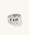 Puffy Charlotte Ring: a bold silver ring with a curved, spiral design from the Charlotte Collection, emphasizing a statement-making aesthetic.