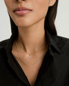A woman wearing a Diamond Letter Charm necklace, highlighting the charm's elegance. Ideal for pairing with additional chain options, sold separately.