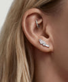Close-up of a woman's ear featuring Gift with Purchase: Lab Grown Sapphire Bold Climber Studs, showcasing mixed lab-grown sapphires in round, marquise, and baguette cuts.