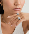 Woman wearing the Puffy Charlotte Ring, a bold, silver piece from the Charlotte Collection, designed to make a statement.