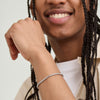 Man with braids wearing a Round Box Chain Bracelet, shown close-up on wrist. Simple, everyday fashion accessory, complements the Round Box Chain Necklace.
