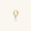 Single Pearl Hoop Charm: A gold hoop earring featuring a delicate dangling pearl, perfect for enhancing your everyday eardrobe with a touch of elegance.