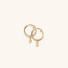 Round Topaz Hoops: A pair of handcrafted 18k gold vermeil hoop earrings adorned with round cut topaz gemstones.