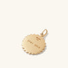 Strength: Rose Coin Charm Pendant - Close-up of a gold medallion with engraved text, symbolizing strength, handcrafted in recycled 14k solid gold.