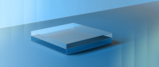 Alt text: A translucent glass cube rests on a gradient blue surface, symbolizing clarity and simplicity in a modern minimalist design.