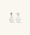 Harley Baroque Pearl Earrings feature oversized baroque pearls with a distinct pebbled texture, evoking a beachy vibe through their unique style and fresh attitude.