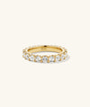 Aurora Lab Grown Sapphire Eternity Ring featuring lab grown sapphires encircling a gold band, embellished with diamonds, showcasing a luxurious, continuous design.