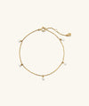 Ama Pearl Bracelet: A delicate gold chain bracelet adorned with miniature freshwater pearls, perfect for adding a summer touch to any outfit.
