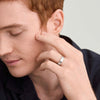 Man touching his face, wearing a 6mm Smooth Band on his finger, showcasing its lightweight design.