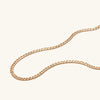 Flat Curb Chain Necklace displayed on a white surface, showcasing its elegant design and fine craftsmanship. Perfect for daily wear and versatile styling.