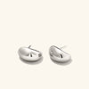 Dôme Huggies earrings from Mejuri, featuring sleek, sculptural design with a rounded vault, perfect for everyday wear and stacking.