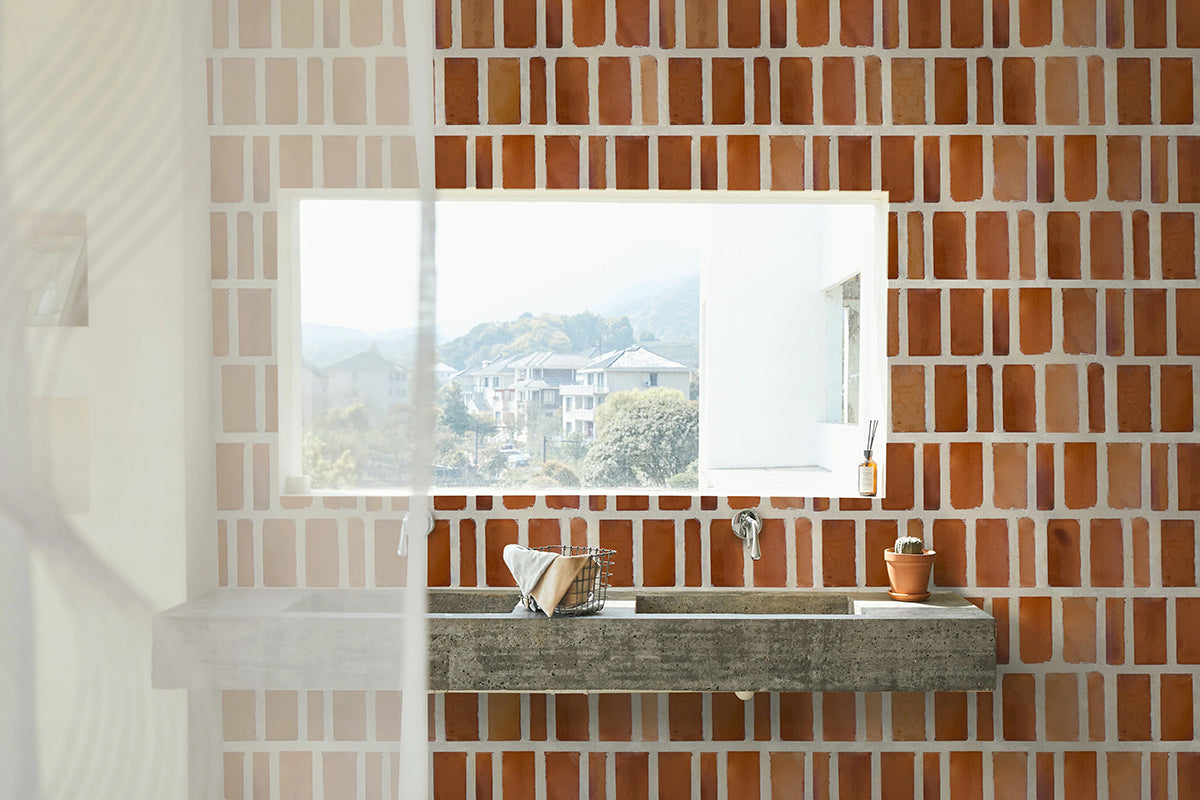 Brick colored terracotta tiles with thick grout lines.