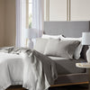 Closeup image of bed made with Signature Hemmed Sheet Set in Stone