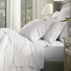 Lifestyle image of bed made with Percale Hemmed Sheet Set in Mineral Delicate Stripe