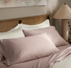 Lifestyle image of bed made with Signature Hemmed Sheet Set in Dusty Rose