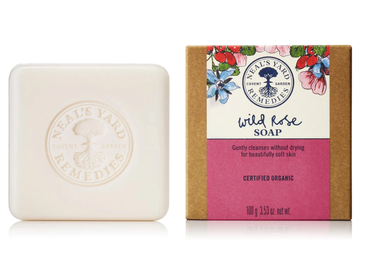 Screenshot showing a bar of Neal's Yard Remedies Wild Rose Soap, embossed with the company logo next to its floral-decorated box labeled for soft skin